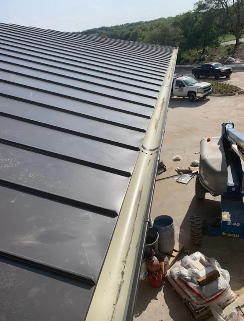 Standing seam panel and gutter detail on a metal roofing jobsite in Brookhaven